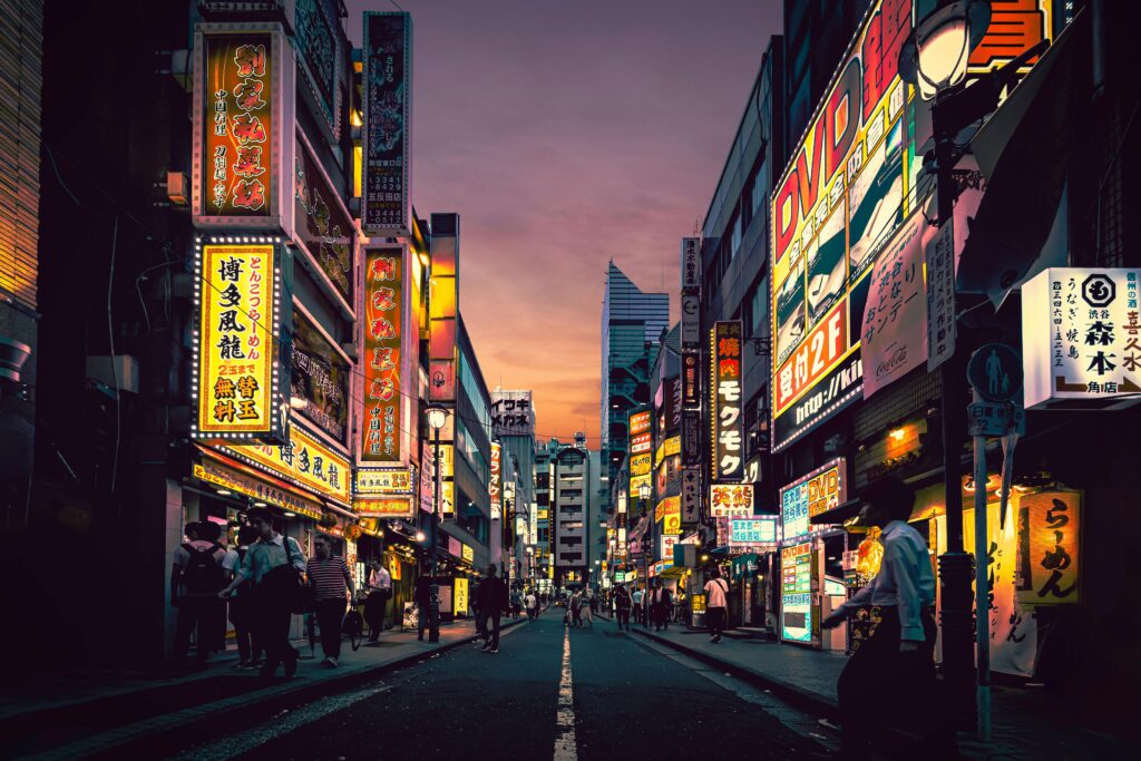Explore the vibrant nightlife of Shibuya, Tokyo, showcasing neon-lit streets bustling with activity after sunset.